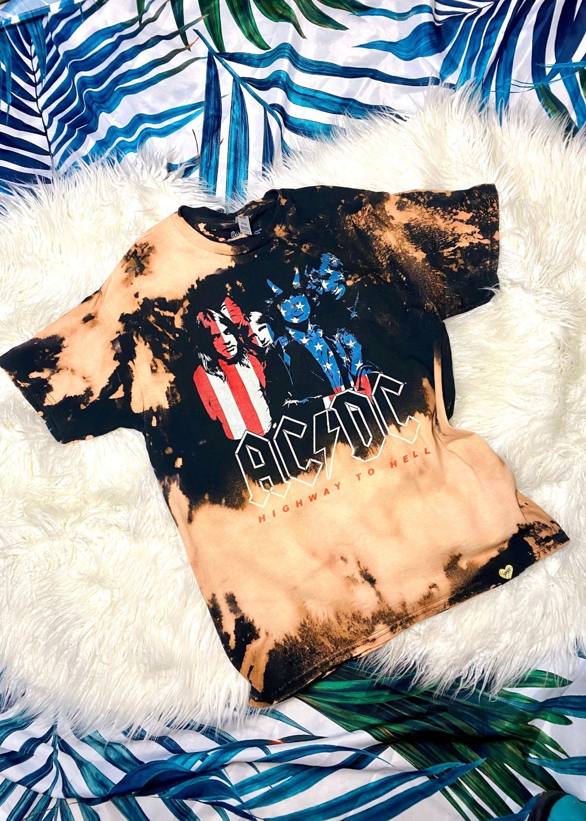 acdc band t shirt with american flag design on a white furry background