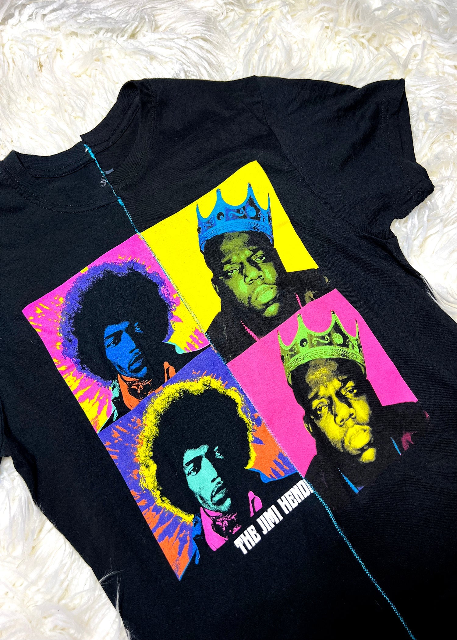 black t shirt on white furry background close up