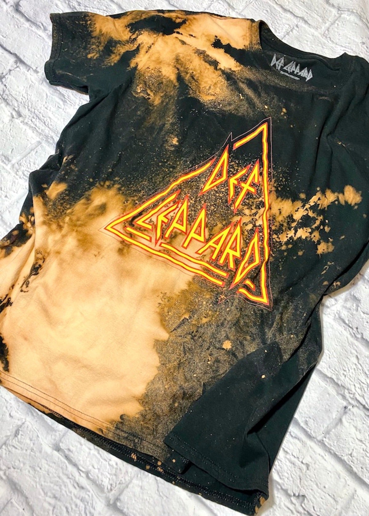 def leppard bleach dye oversized t shirt on a white brick background
