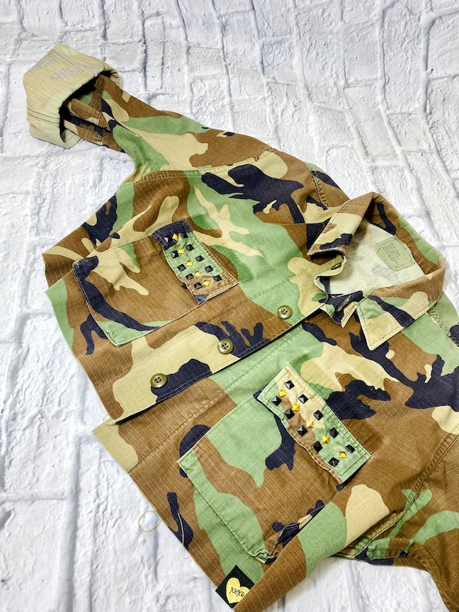 rock n roll camo jacket on a white brick background front