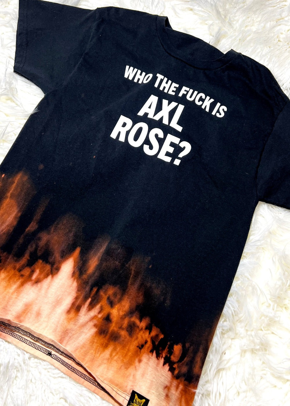 bleach dye t shirt on a white furry background angled view