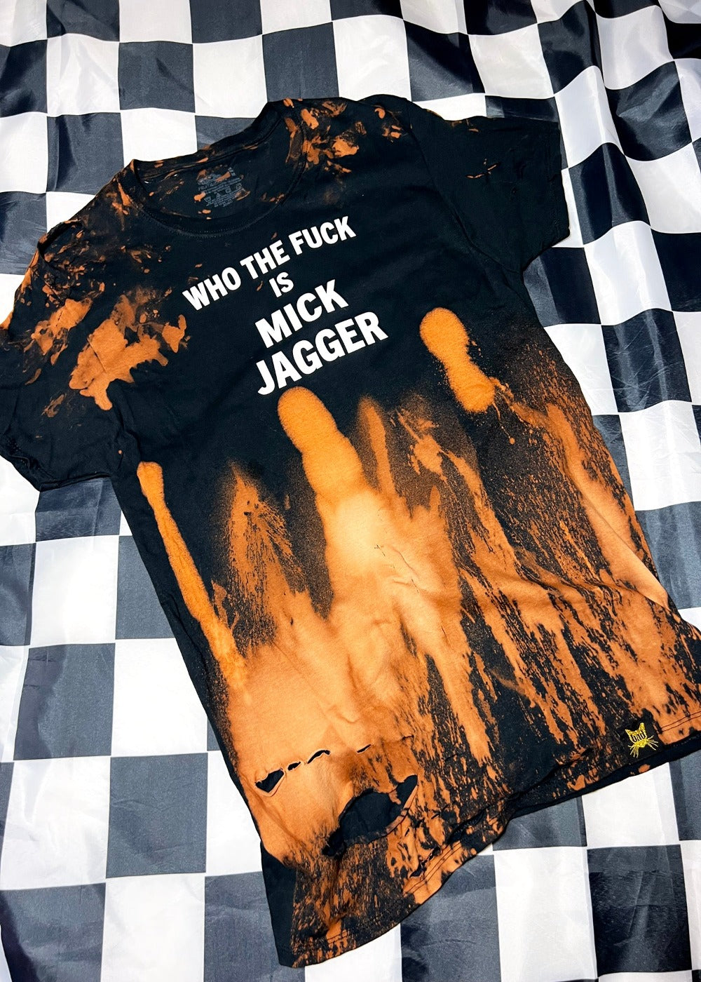 bleach dye t shirt on black and white checkerboard background