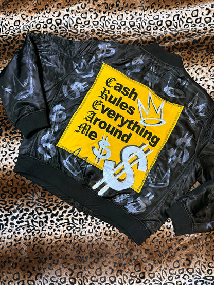 Black jacket with a yellow patch on a leopard print background