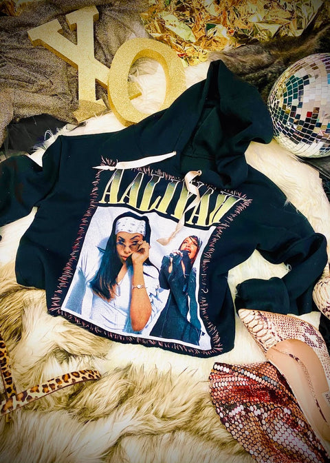 black aaliyah cropped hoodie on furry rug with disco ball and sequins
