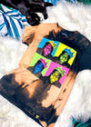 biggie bleach dye t shirt on a white furry background with black and white cat