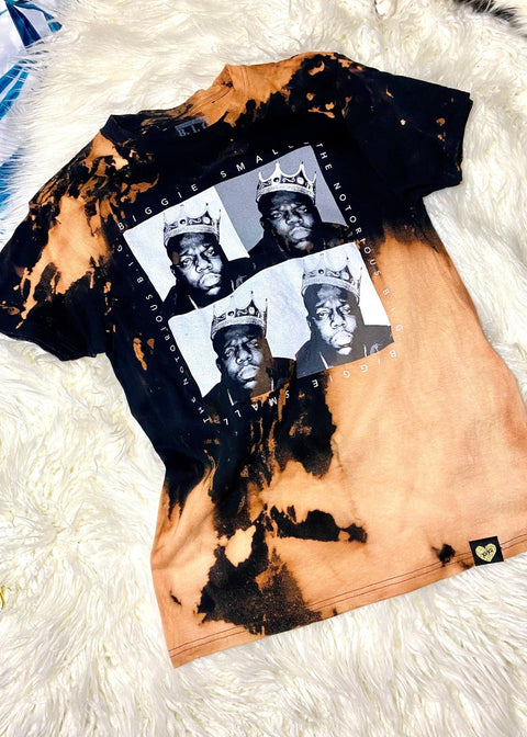 biggie bleach dye t shirt on a white furry background shot from above