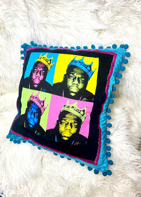 biggie throw pillow on a white furry background angle view