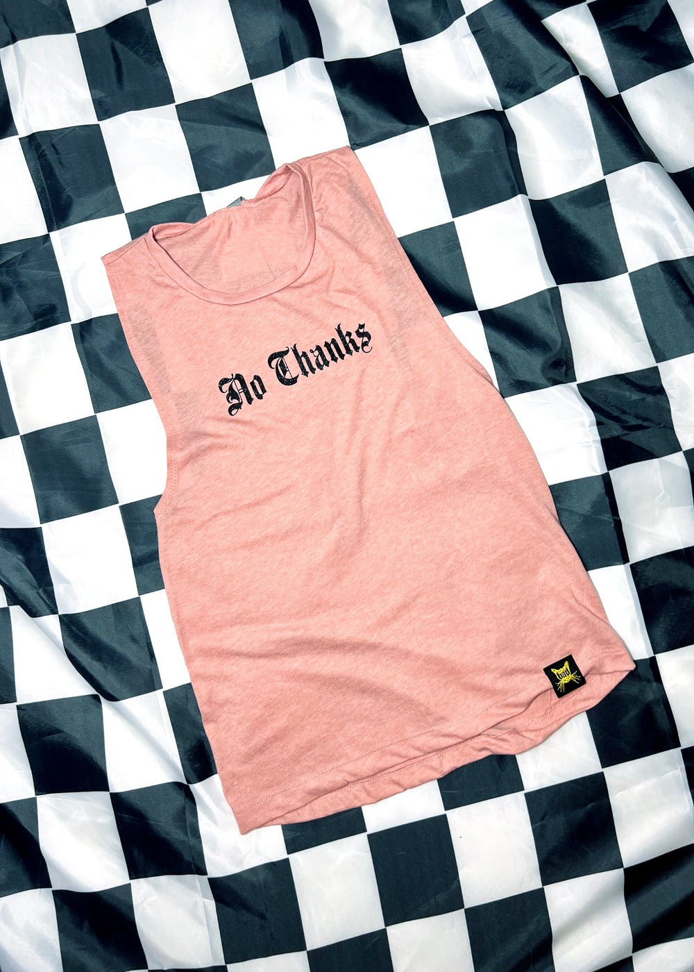 rose colored tank top on a black and white checkerboard background