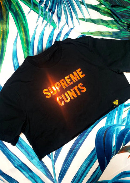 black graphic crop t shirt on a palm background close up