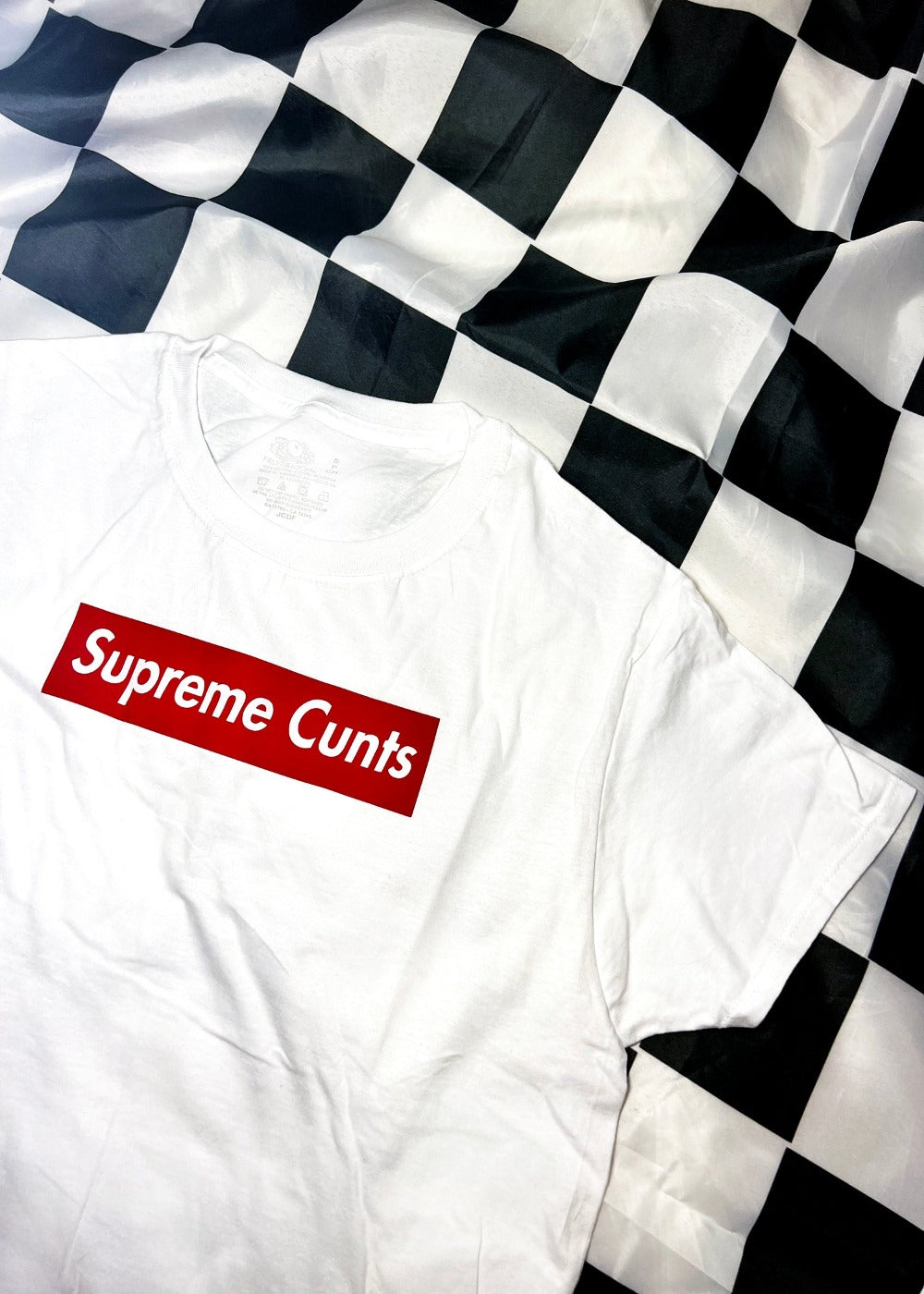 white t shirt on a black and white checkerboard background angle view