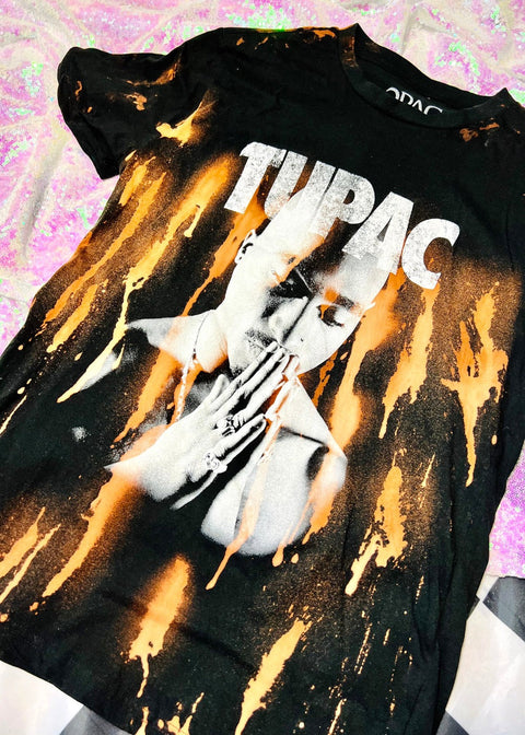 tupac bleach dye t shirt on a sequin background close up