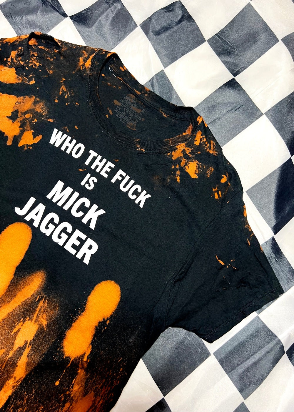 bleach dye t shirt on black and white checkerboard background angled view